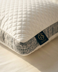 Quilted pillow with a brand label on a light background
