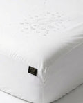 White mattress cover with a brand logo on a white background