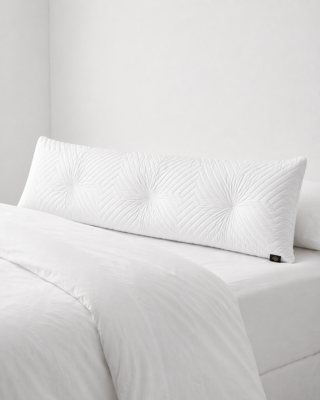 White textured pillow on a bed with a neutral background