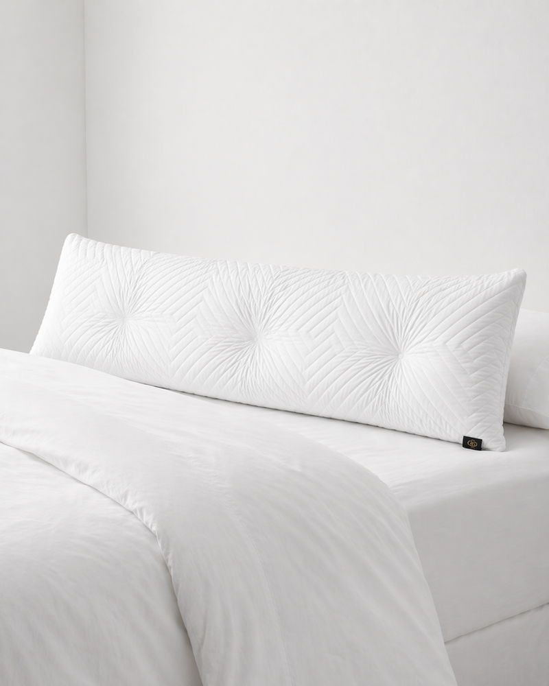 White textured pillow on a bed with a neutral background